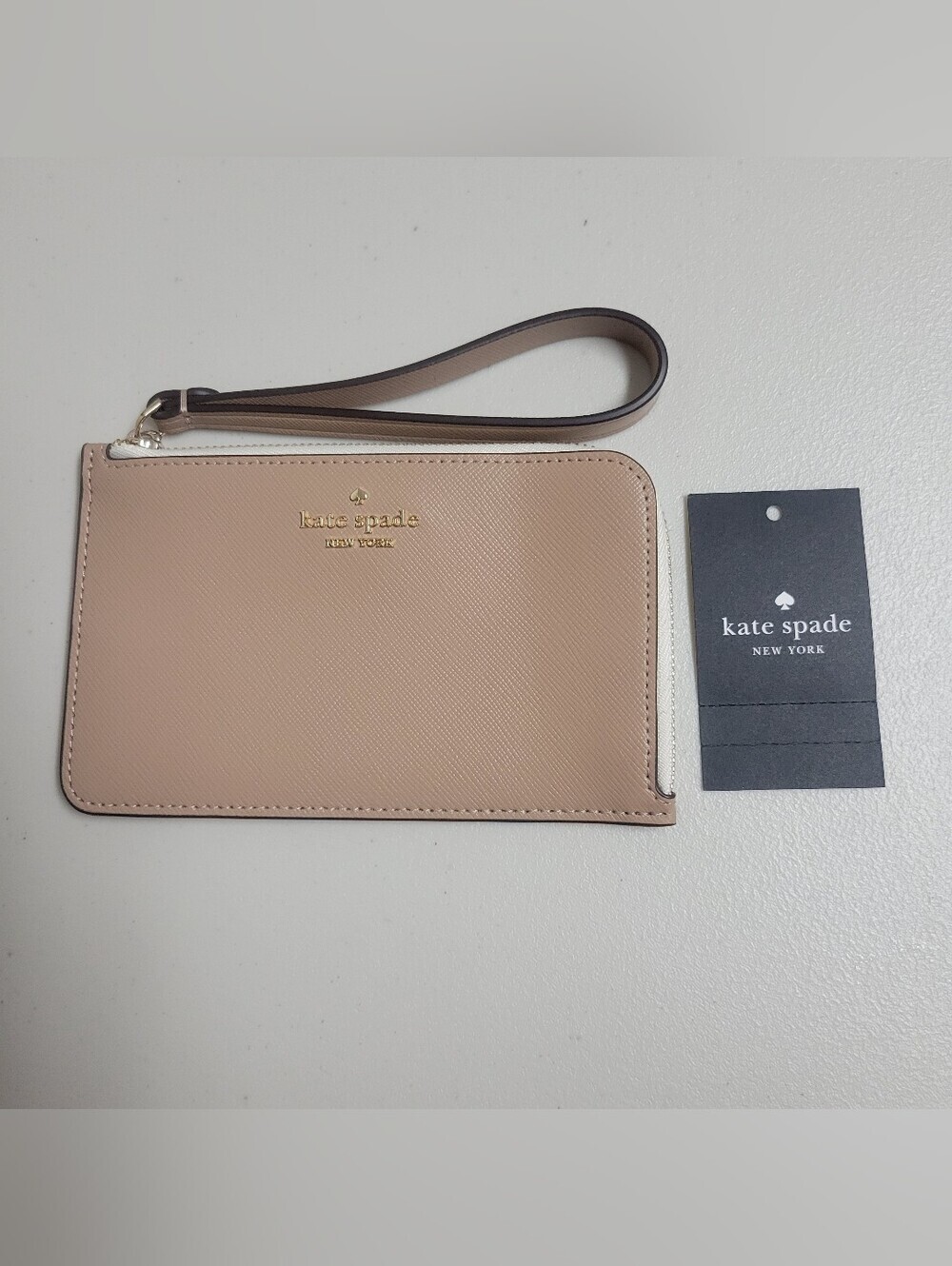 kate spade NWOT blush pink saffiano wristlet pouch with gold logo.